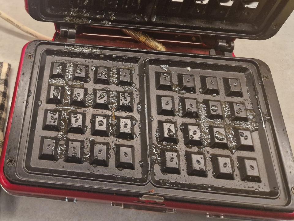 square waffle iron with oil on it