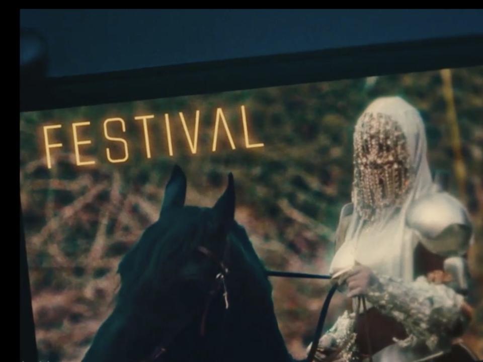 Dre holds her phone, showing an image of Ni'Jah in glittery body armor riding a horse for her "Festival" album on "Swarm."