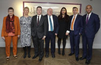 Seven MPs from left, Ann Coffey, Angela Smith, Chris Leslie, Mike Gapes, Luciana Berger, Gavin Shuker and Chuka Umunna, pose for a photograph after a press conference to announce the new political party, The Independent Group, in London, Monday, Feb. 18, 2019. Seven British Members of Parliament say they are quitting the main opposition Labour Party over its approach to issues including Brexit and anti-Semitism. Many Labour MPs are unhappy with the party's direction under leader Jeremy Corbyn, a veteran socialist who took charge in 2015 with strong grass-roots backing. (AP Photo/Kirsty Wigglesworth)