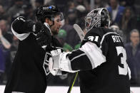 Los Angeles Kings right wing Adrian Kempe, left, celebrates with goaltender David Rittich (31) after the Kings defeat the New York Islanders in an NHL hockey game in Los Angeles, Monday, March 11, 2024. (AP Photo/Alex Gallardo)