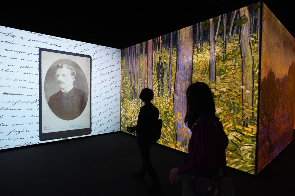 Visitors walk through an exhibition about the life and works of Dutch painter Vincent van Gogh, in Beijing on June 16, 2016. The exhibition, titled "Meet Vincent van Gogh," was created by the Van Gogh Museum and had its global launch in Beijing on June 15. Featuring reproductions of his work and recreations of scenes he painted, the exhibition is scheduled to tour cities across Greater China over the next five years.