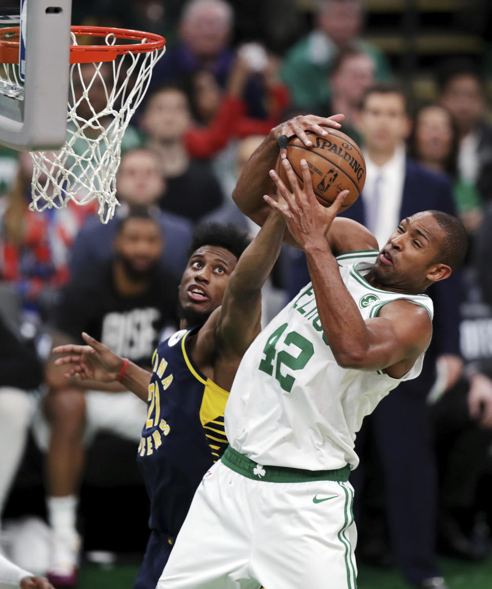 Boston Celtics center Al Horford (42) hauls down a rebound against Indiana Pacers forward Thaddeus Young (21) during the fourth quarter of Game 2 of an NBA basketball first-round playoff series, Wednesday, April 17, 2019, in Boston. The Celtics won 99-91. (AP Photo/Charles Krupa)