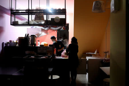 Du Yueting, 42, prepares breakfast for her girlfriend Zhang Tongyu, 35, to take to work early in the morning at their restaurant, in New Taipei City, Taiwan, November 20, 2018. REUTERS/Ann Wang