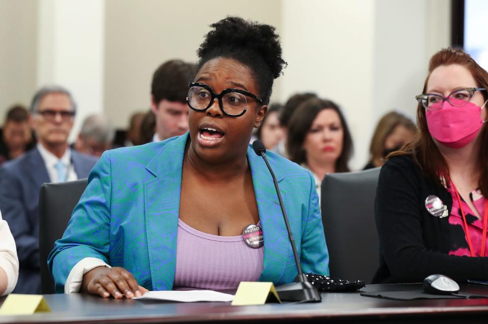 Shauntrice Martin testifies about the difficulty she faced in receiving an abortion several years ago as Tamarra Wieder, right, Kentucky state director of Planned Parenthood, listens during a hearing before the Senate Judiciary Committee at the Capitol Annex in Frankfort. March 10, 2022