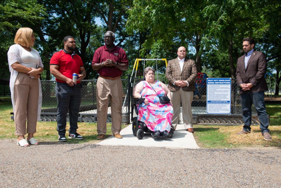 Director of Parks & Recreation Tony Black (middle left) speaks during the unveiling of the wheelchair accessible swing at Malesus Park in Jackson, Tennessee on July 26, 2023.