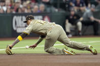 San Diego Padres third baseman Manny Machado is unable to make a play on a single by Arizona Diamondbacks' Christian Walker during the fourth inning of a baseball game Sunday, May 5, 2024, in Phoenix. (AP Photo/Ross D. Franklin)