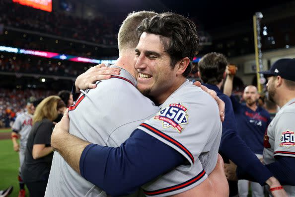 HOUSTON, TEXAS - NOVEMBER 02: Luke Jackson #77 of the Atlanta Braves celebrates with Will Smith #51 on the field after defeating the Houston Astros 7-0 in Game Six of the World Series at Minute Maid Park on November 02, 2021 in Houston, Texas. (Photo by Elsa/Getty Images)