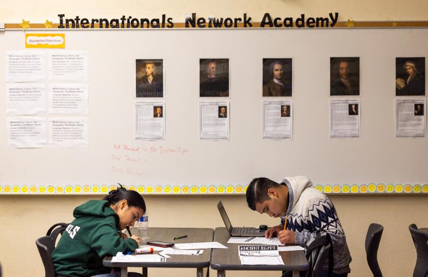 Los Angeles, CA - January 22: 10th grade world history students Leonara F., left and Walter C. work on their school work at The Internationals Network Academy at Belmont High School. The Internationals Network Academy was established to help immigrant children - most of whom are unaccompanied minors - get adjusted to the education system in L.A. Photo taken at Belmont High School in Los Angeles Monday, Jan. 22, 2024. (Allen J. Schaben / Los Angeles Times)