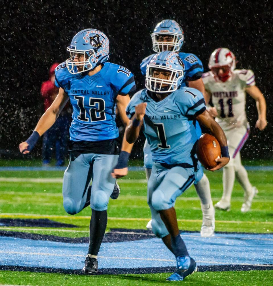 Central Valley's Deniro Simpson takes a Laurel Highlands blocked field goal back for a touchdown to end the 2nd quarter of their WPIAL playoff game Friday at Central Valley High School. [Lucy Schaly/For BCT]