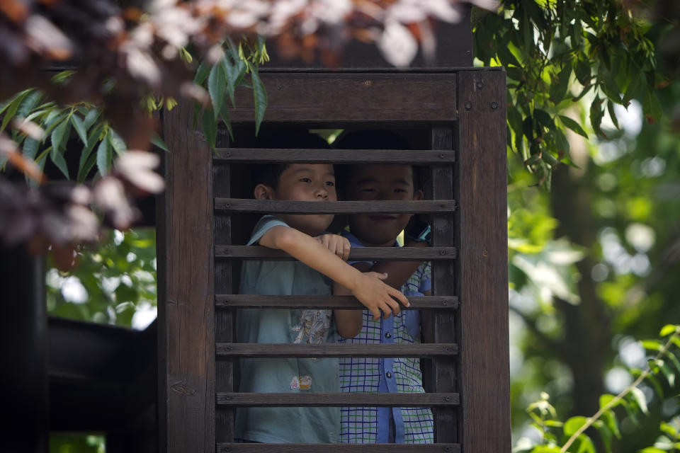 Children climb on a pavilion to watch the dragon boat races during the Dragon Boat Festival at a canal in Tongzhou, outskirts of Beijing, Monday, June 10, 2024. The Duanwu Festival, also known as the Dragon Boat Festival, falls on the fifth day of the fifth month of the Chinese lunar calendar and is marked by eating rice dumplings and racing dragon boats. (AP Photo/Andy Wong)