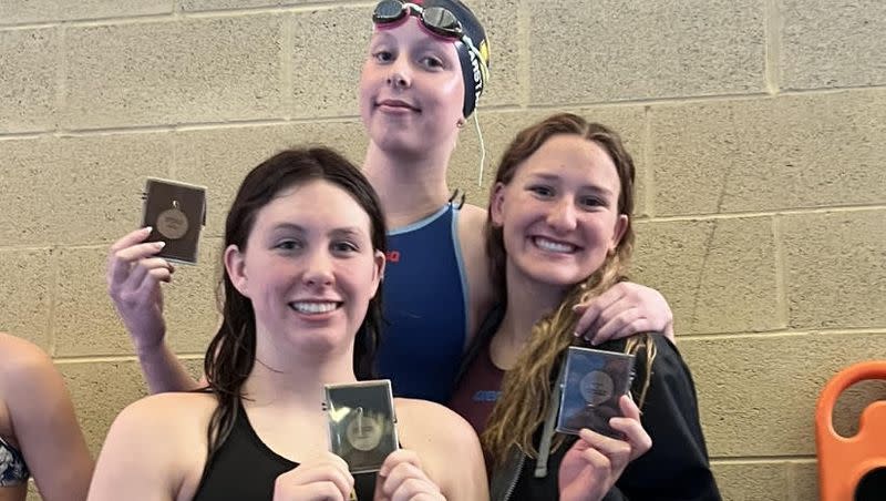 Skyline’s Jade Garstang, top, receives her Region 6 first-place medal after breaking the 100 butterfly overall state record on Friday at the South Davis Rec Center. Also pictured is Highland’s Ellinor Plant, left, and Highland’s Veronica Black.