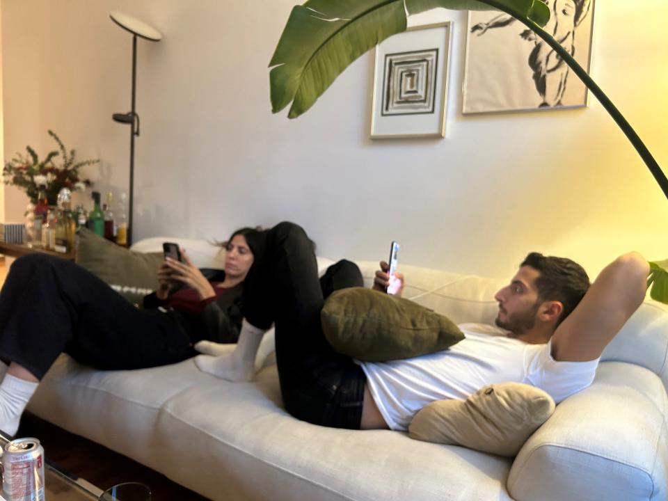 Liam Zeitchik, right, and his sister Alan Zeitchik, left, look at their phones for updates from the Brooklyn home of Liam after Secretary of State Antony Blinken on Friday Oct. 20 announced the release of two American hostages who were held captive in Hamas in Gaza.