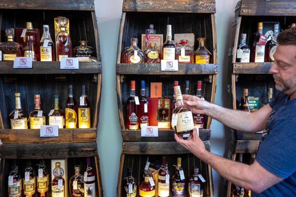 Brad Bonds, of Revival Spirits in Covington, Ky., holds a vintage bottle of bourbon Tuesday, May 9, 2023. Revival is among the largest liquor stores buying and selling under the Kentucky Vintage Distilled Spirits law. They buy bourbons and other spirits unavailable elsewhere then sell by the drink, or by the bottle. Customers can taste a 40-year-old bourbon for $5. Ryan C. Hermens/rhermens@herald-leader.com