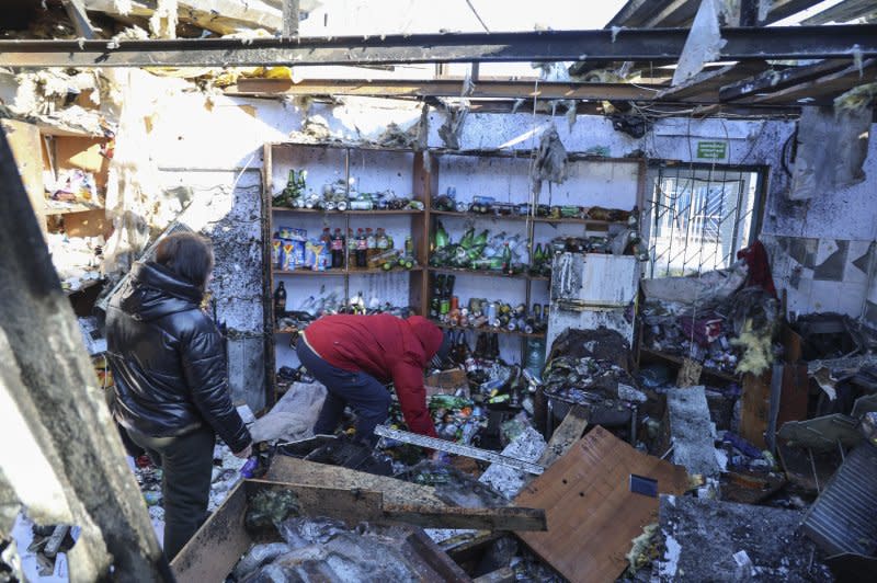 People comb through the damage after the shelling of a food market in Donetsk, Ukraine, on January 21. File Photo by Alessandro Guerra/EPA-EFE