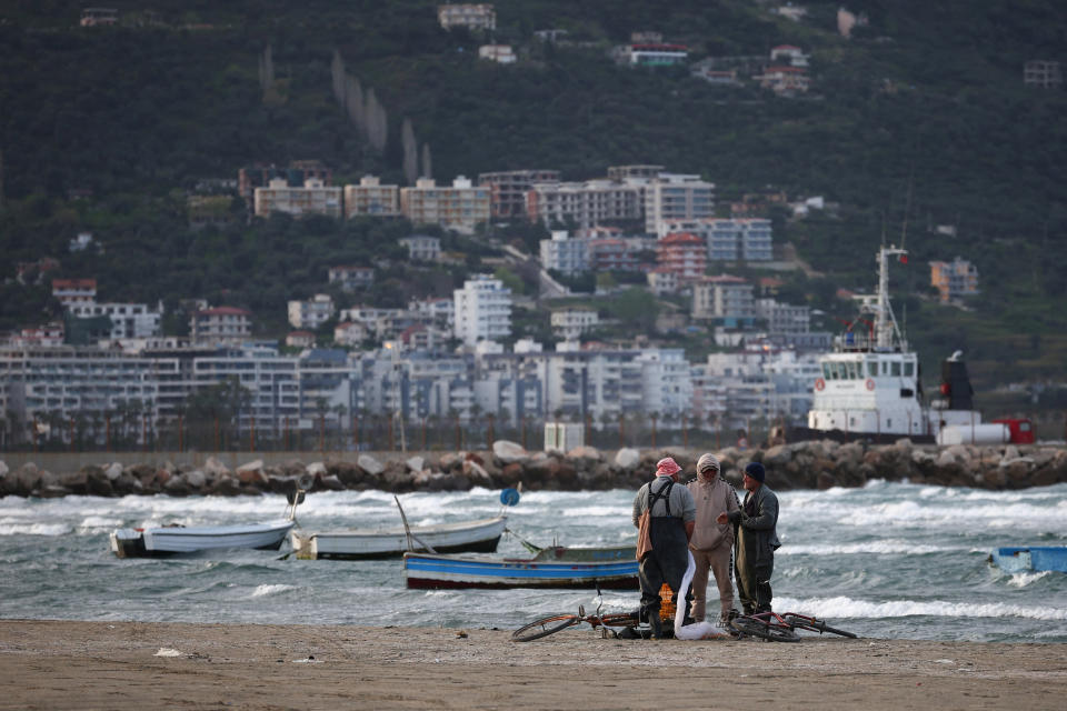 Fishermen stand by the sea in Vlora, Albania, April 1, 2024. REUTERS/Florion Goga
