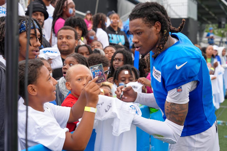 WR Jameson Williams signs autographs after the Detroit Lions training camp at their training facility in Allen Park, Mich. on Monday, July 29, 2024.