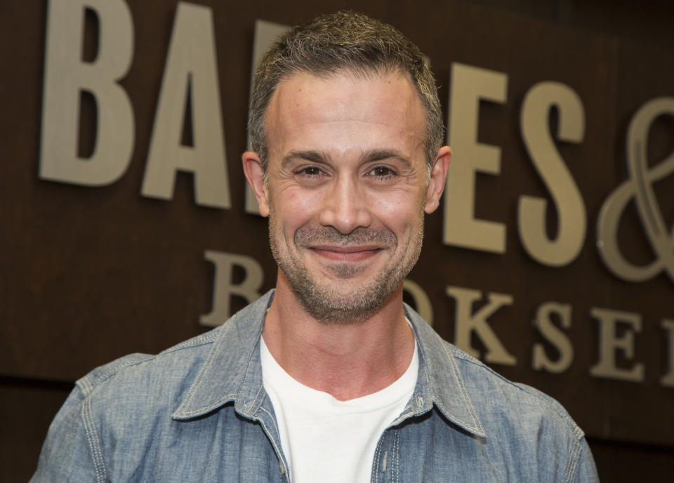 Freddie Prinze Jr. with short, dark hair and facial stubble