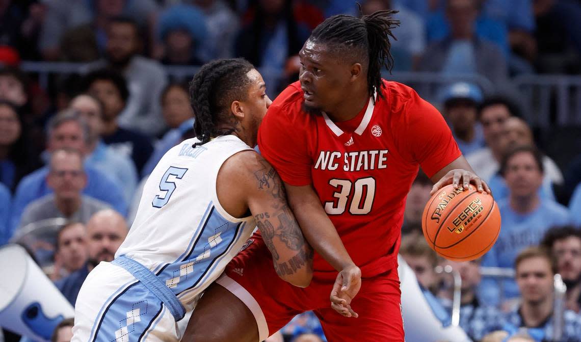 N.C. State’s DJ Burns Jr. (30) works against North Carolina’s Armando Bacot (5) during the first half of N.C. State’s game against UNC in the championship game of the 2024 ACC Men’s Basketball Tournament at Capital One Arena in Washington, D.C., Saturday, March 16, 2024.