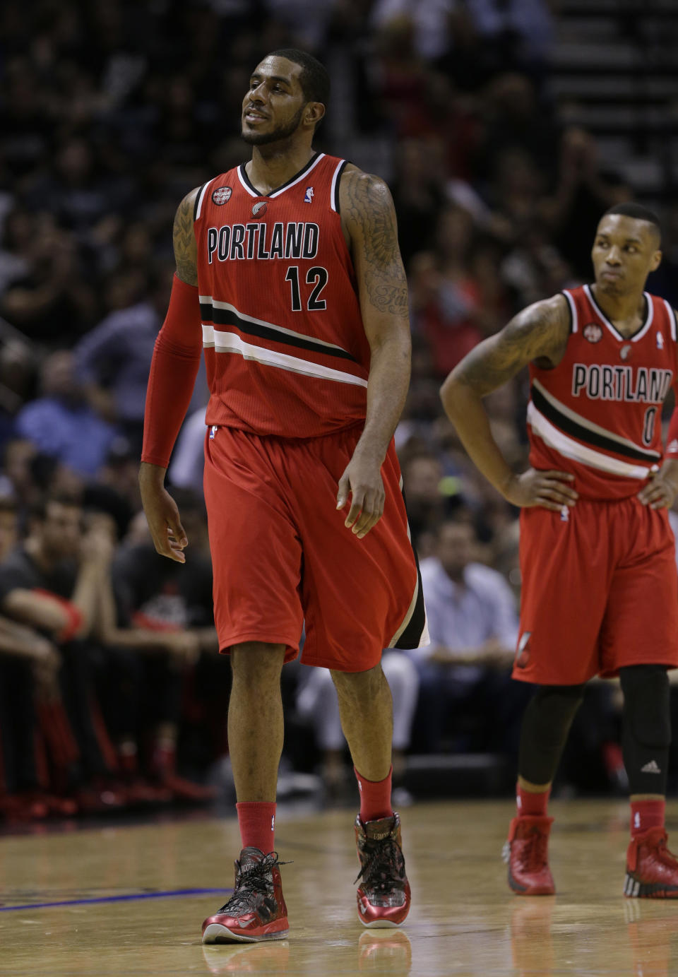 Portland Trail Blazers’ LaMarcus Aldridge (12) and Damian Lillard (0) during the second half of Game 5 of a Western Conference semifinal NBA basketball playoff series against the San Antonio Spurs, Wednesday, May 14, 2014, in San Antonio. (AP Photo/Eric Gay)