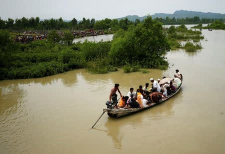 FILE PHOTO: A boat carrying Rohingya refugees is seen leaving Myanmar through Naf river in Maungdaw, Myanmar, September 7, 2017. REUTERS/Mohammad Ponir Hossain/File Photo