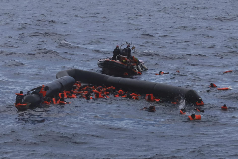 FILE - In this Wednesday, Nov. 11, 2020 file photo, refugees and migrants are rescued by members of the Spanish NGO Proactiva Open Arms, after leaving Libya trying to reach European soil aboard an overcrowded rubber boat in the Mediterranean sea. Tunisian authorities say 20 African migrants have been found dead after their boat, which was trying to reach Europe, sank in the Mediterranean Sea. Five survivors were rescued Thursday, Dec. 24, 2020 and authorities are searching for up to 20 others believed missing. (AP Photo/Sergi Camara, File)