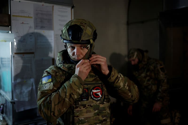 Hairdresser and Ukrainian Territorial Defence unit volunteer works at a beauty salon, in Kyiv