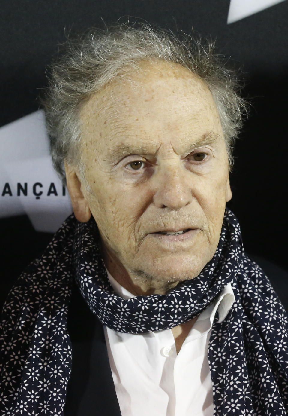 FILE - French actor Jean-Louis Trintignant, poses as he arrives for the pre-premier of the movie Love at the Cinematheque Francaise, in Paris, Monday, Oct. 15, 2012. French film legend and amateur racecar driver Jean-Louis Trintignant, who earned acclaim for the Oscar-winning "A Man and a Woman" a half a century ago and went on to portray the brutality of aging in his later years, has died at 91. (AP Photo/Michel Euler, File)