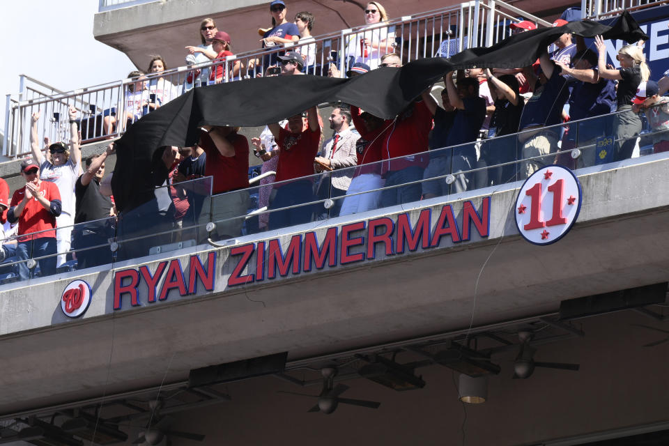 Former Washington Nationals baseball player Ryan Zimmerman's name and jersey number is unveiled on the upper deck at his jersey retirement ceremony before a baseball game between the Nationals and the Philadelphia Phillies, Saturday, June 18, 2022, in Washington. (AP Photo/Nick Wass)