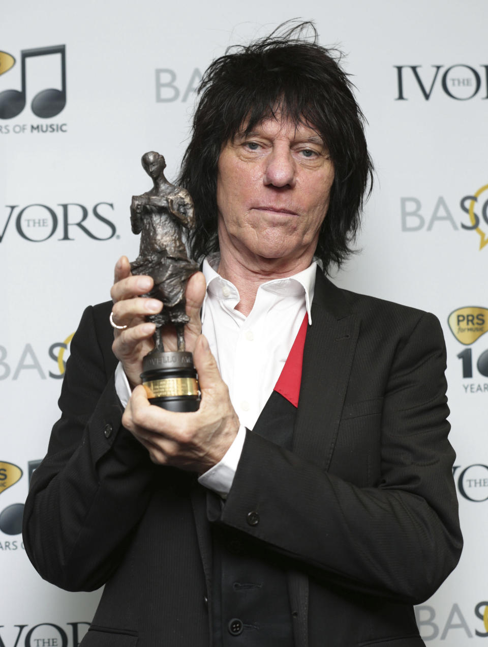 FILE - Jeff Beck holds his Outstanding Contribution to British Music award, at the 59th annual Ivor Novello Awards, at Grosvenor House, in London, on May 22, 2014. Renowned rock guitarist Beck, known for his work with the Yardbirds and the Jeff Beck Group, has died Tuesday, Jan. 10, 2023, at the age of 78, his representatives said Wednesday. (Yui Mok/PA via AP)