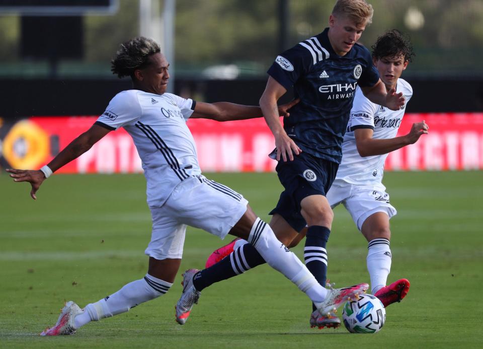 Philadelphia Union midfielder Jose Andres Martinez (8) and New York City FC midfielder Keaton Parks (55) fight to control the ball during the first half at ESPN Wide World of Sports.