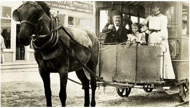 Children enjoyed riding up front with the conductor of the mule-drawn trolley.