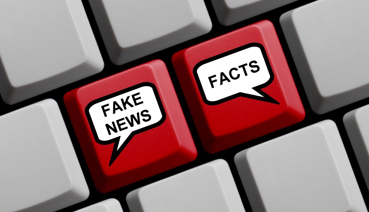 Red Computer Keyboard with balloons showing Fake News or Facts