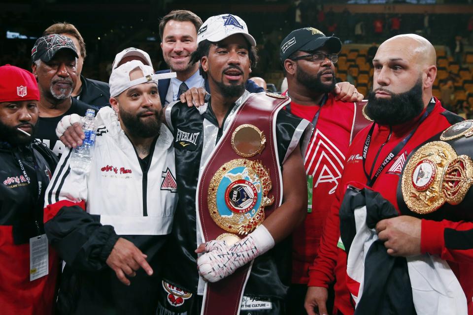 FILE - In this Oct. 21, 2018, file photo, Demetrius Andrade, center, stands with members of his team after defeating Walter Kautondokwa in a WBO middleweight championship boxing match in Boston. Andrade is just a few months from winning a middleweight title but perhaps still far away from fights with the division’s biggest names. Canelo Alvarez, Gennady Golovkin and Daniel Jacobs are the headliners at 160 pounds, and while perhaps one or more of them could someday be in Andrade’s future, it doesn’t appear to be the near future. (AP Photo/Michael Dwyer, File)