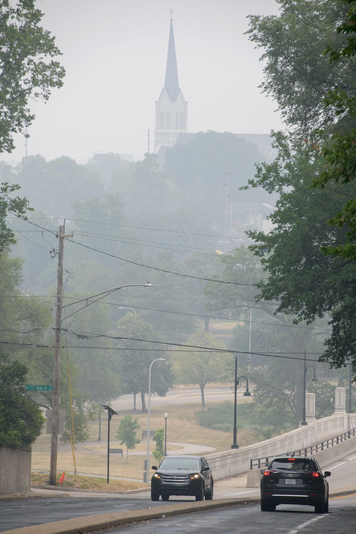 The steeple of St. Joseph Church is seen through a thick haze covering the region Wednesday, June 28, 2023 in Peoria.