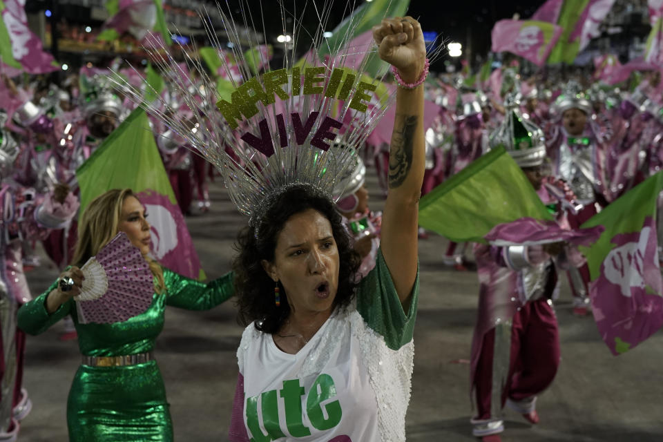 Monica Benicio, widow of slain councilwoman Marielle Franco raises her fist as she parades during the perform of the Mangueira samba school during Carnival celebrations at the Sambadrome in Rio de Janeiro, Brazil, Tuesday, March 5, 2019. (AP Photo/Leo Correa)