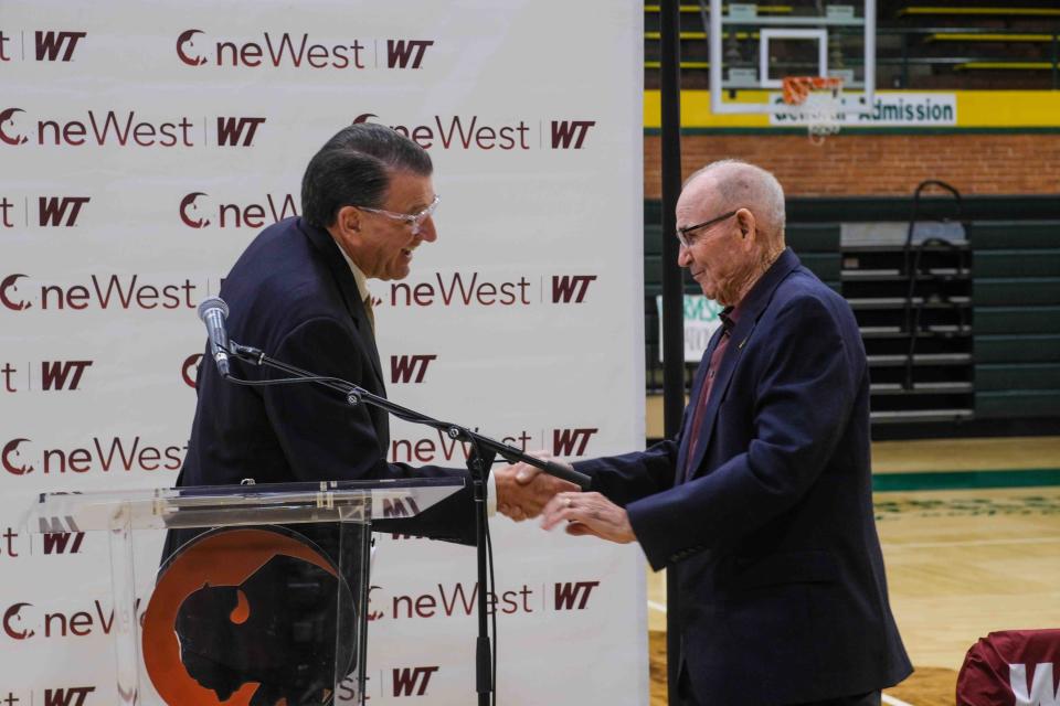 West Texas A&M University President Walter Wendler greets retired businessman Bill Cofer at WT's announcement at Pampa High School on Thursday celebrating Cofer's $1.5 million endowment to local students.