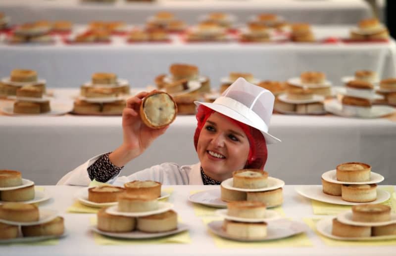 A judge assesses pies during a competition in Scotland. In pie-loving countries around the world, March 14 - or 3.14 - is celebrated as pi day. Andrew Milligan/PA Wire/dpa