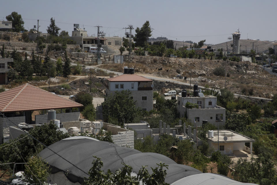 The Israeli army post, right, over looks the shooting site, as seen from the family house of slain Palestinian Mohammed al-Alami, 12, in the West Bank village of Beit Ummar, near Hebron, Wednesday, Aug. 4, 2021. (AP Photo/Nasser Nasser)