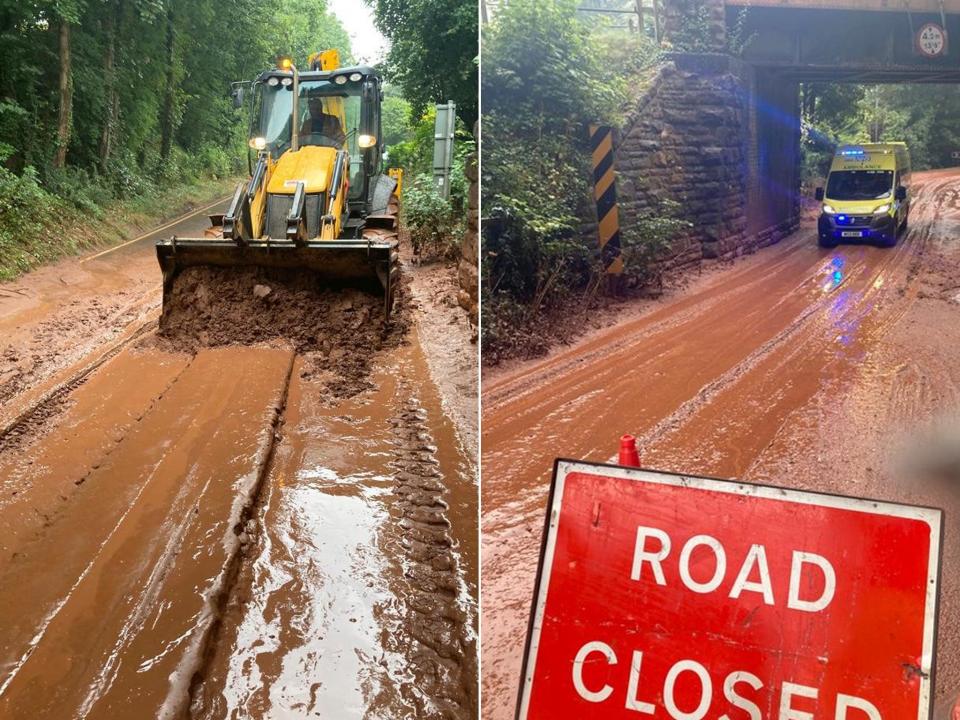 Emergency responders work to clear mud from the road (SWNS)