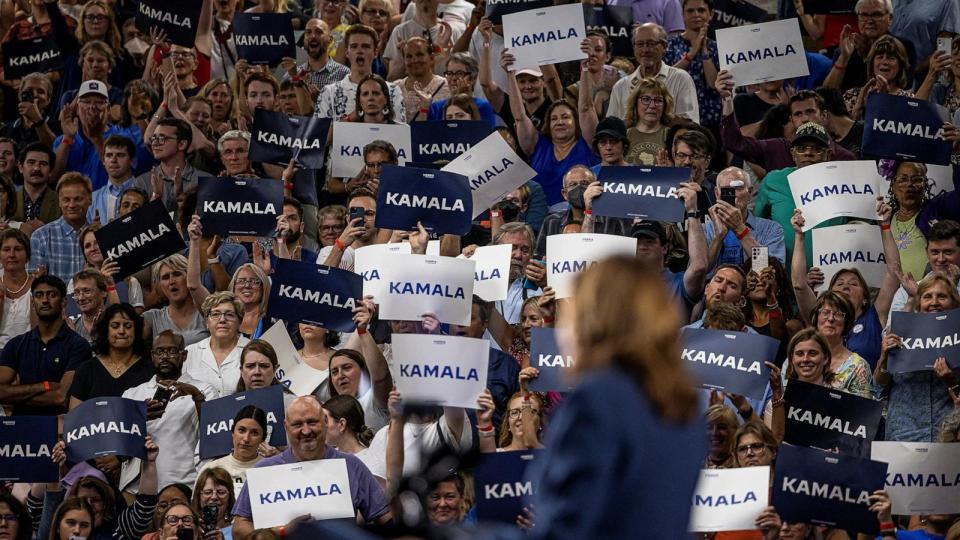 PHOTO: People raise signs in support of Vice President Kamala Harris as she speaks at a campaign event at West Allis High School in West Allis, Wisconsin, July 23, 2024.  (Kevin Mohatt/Reuters)