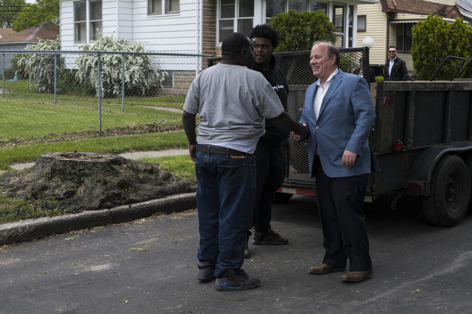 Detroit Mayor Mike Duggan with a local resident working on a landscaping job in the Fitzgerald neighborhood of Detroit. (Photo: Brittany Greeson for Yahoo News)