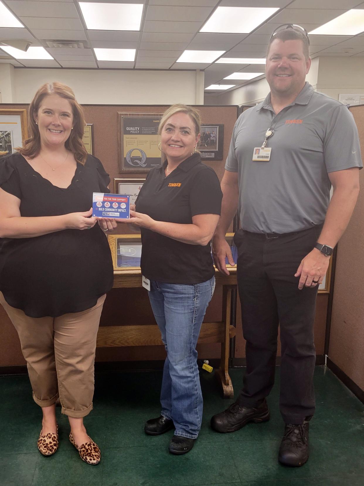 United Way of North Central Ohio Executive Director Amber Wertman presents an award thanking Timken for its support as a top community campaign corporate donor