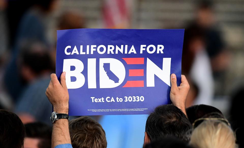 Supporters of Democratic presidential hopeful former Vice President Joe Biden hold signs to show their support as they await his arrival for a Super Tuesday event in Los Angeles on March 3, 2020. (Photo by Frederic J. BROWN / AFP) (Photo by FREDERIC J. BROWN/AFP via Getty Images)