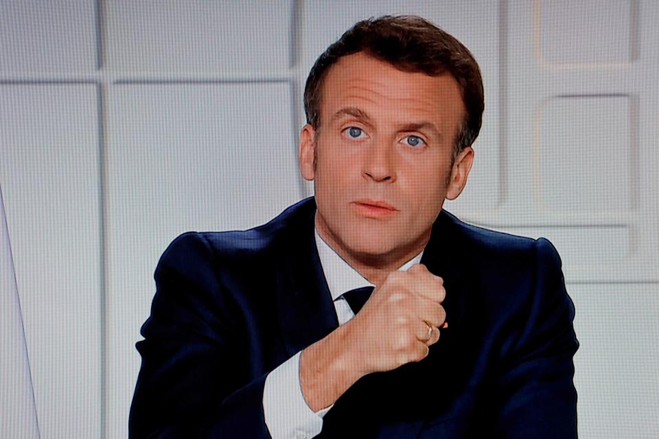 French President Emmanuel Macron is seen on a TV screen as he speaks during a televised address on the new Covid-19 restrictions from the Elysee Palace in Paris on March 31, 2021. (Photo by Ludovic MARIN / AFP) (Photo by LUDOVIC MARIN/AFP via Getty Images)