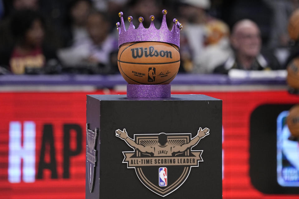 A purple crown is placed on a basketball ahead of a ceremony honoring Los Angeles Lakers forward LeBron James as the NBA's all-time leading scorer before an NBA game against the Milwaukee Bucks on Thursday, Feb. 9, 2023, in Los Angeles. James passed Kareem Abdul-Jabbar to earn the record during Tuesday's NBA game against the Oklahoma City Thunder. (AP Photo/Mark J. Terrill)