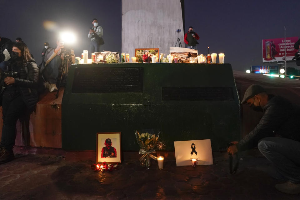 Journalists cover a vigil in honor of news photographer Margarito Martinez, Friday, Jan. 21, 2022, in Tijuana, Mexico. Martinez, a Tijuana-based photojournalist who specialized in covering gritty crime scenes in this border city, was shot as he left his home on Jan 17. (AP Photo/Gregory Bull)