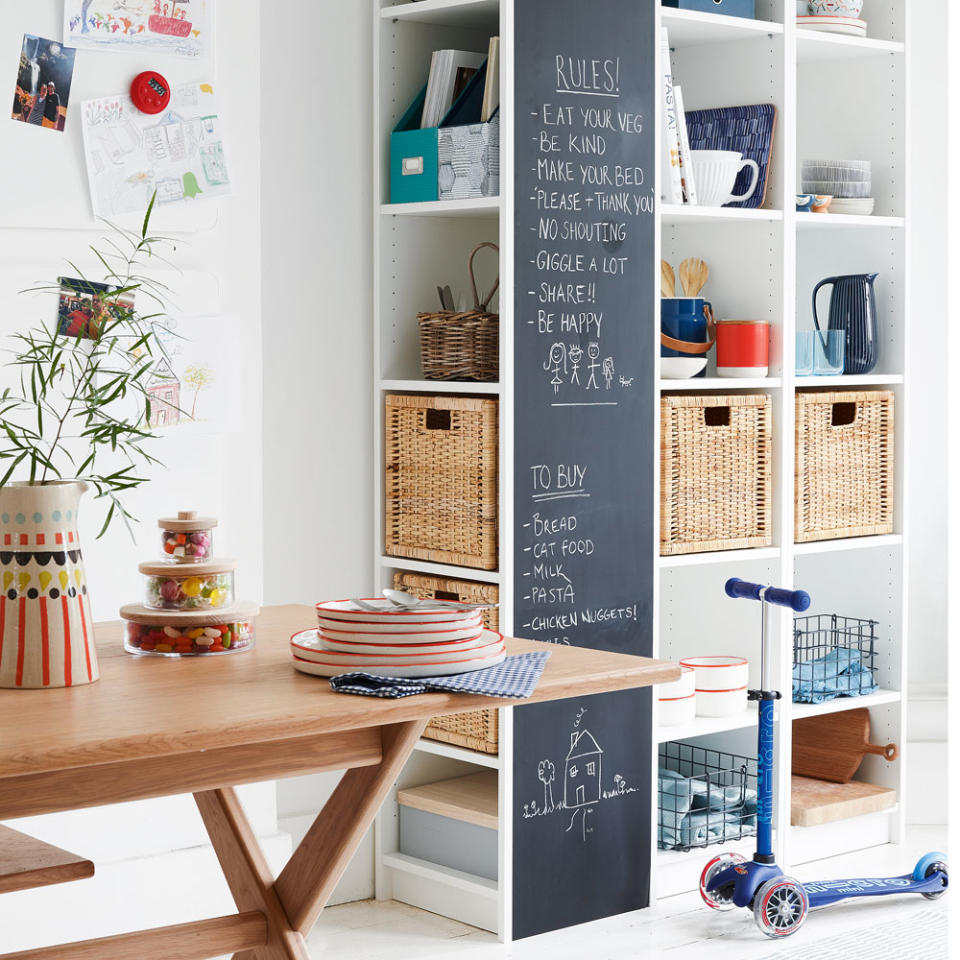 white kitchen with bookcase for storage