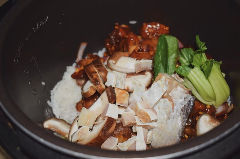 Rice pot filled with ingredients before cooking