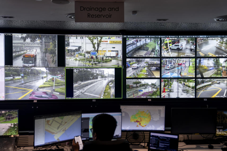 Workers monitor drainage and reservoir cameras for problems during a heavy rain from a command room at PUB, Singapore's National Water Agency, in Singapore, Thursday, July 20, 2023. The room is part of Singapore's cutting-edge water management system that combines technology, diplomacy and community involvement to help one of the most water-stressed nations in the world secure its water future. The country's innovations have attracted the attention of other water-scarce nations seeking solutions. (AP Photo/David Goldman)