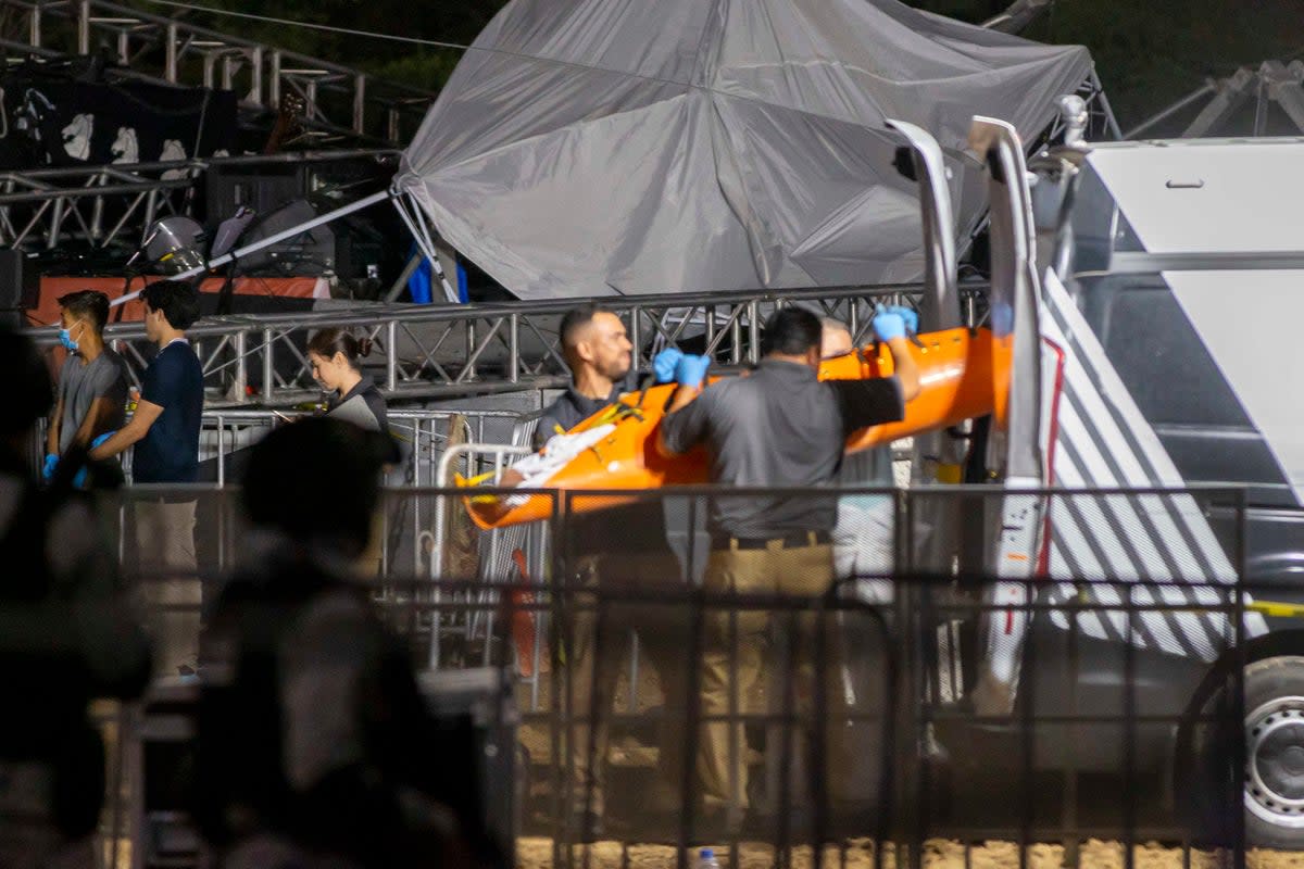 Forensic personnel move a body after a stage collapsed during a campaign rally in San Pedro Garza Garcia (AFP via Getty Images)